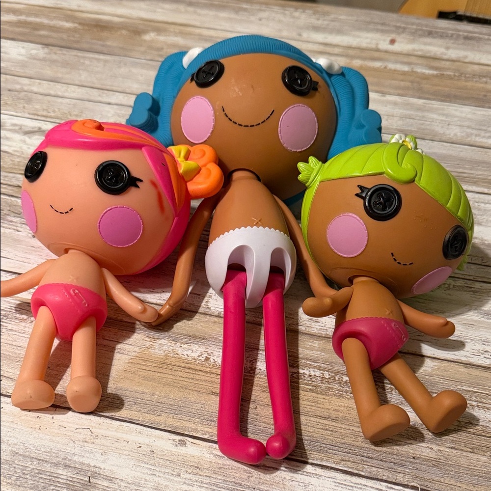 Adorable Trio of Dolls with Pink, Orange, and Green Accents